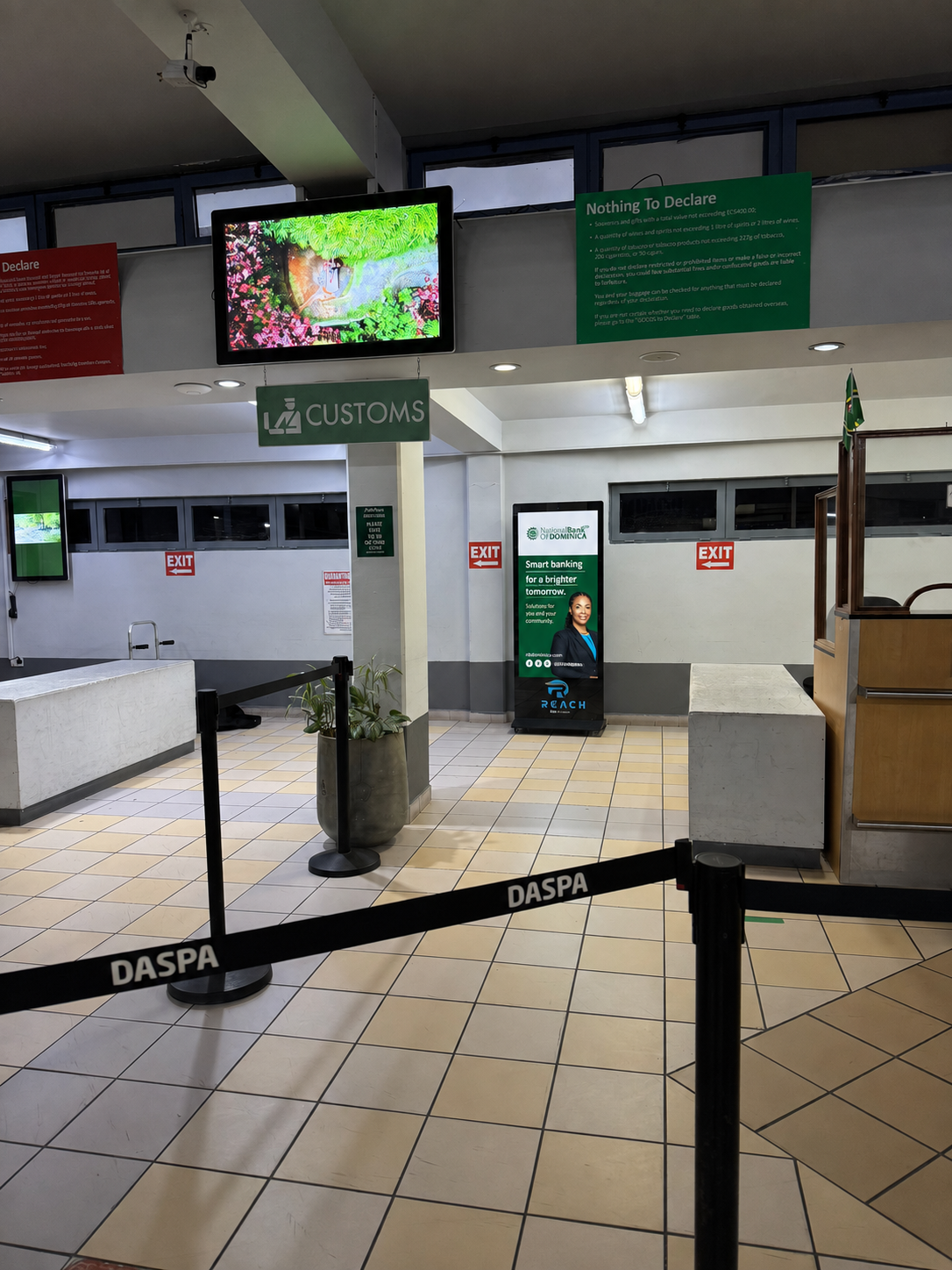 NBD campaign mockup on Reach Media screen at Douglas-Charles Airport