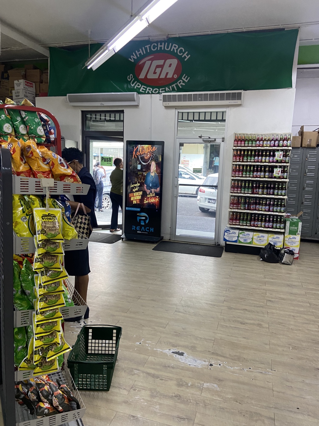 Reach Media screen inside Witchurch IGA with shoppers nearby